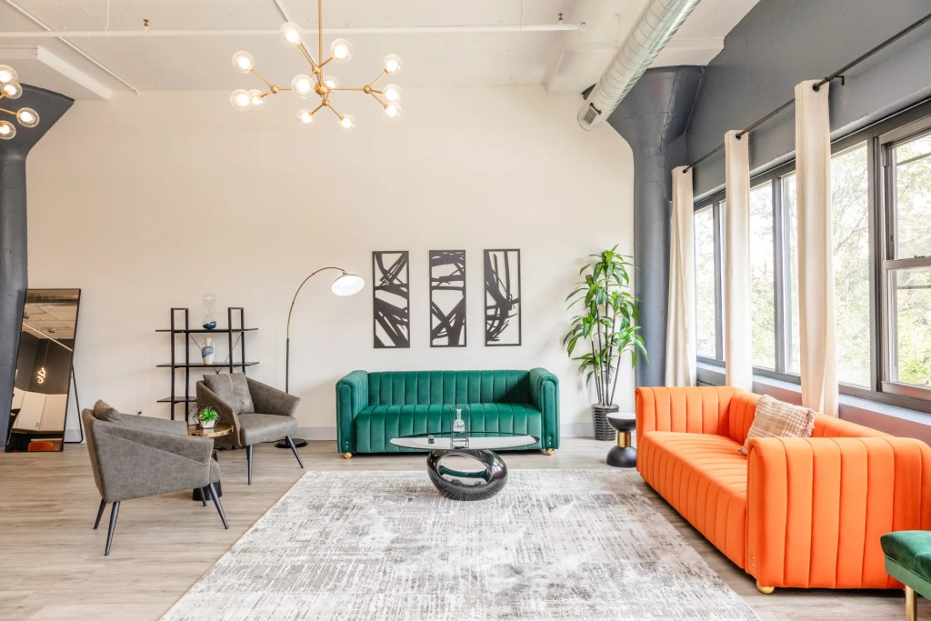 living room with green and orange sofas
