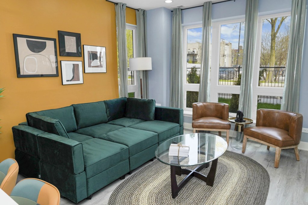 living room with yellow wall and leather accent chairs