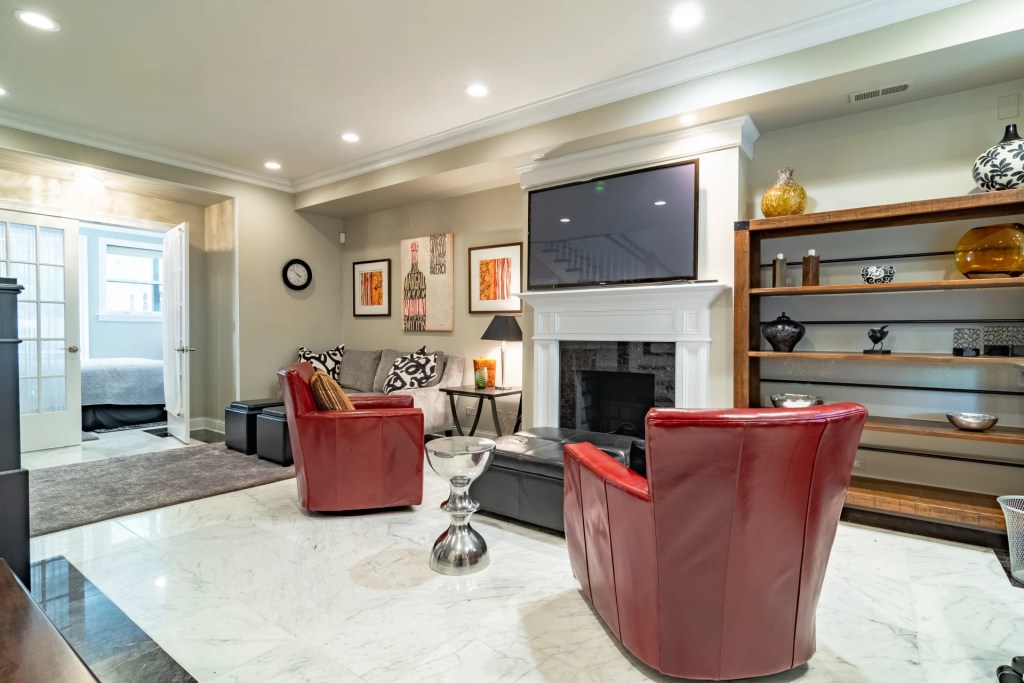 lliving room with red accent chairs